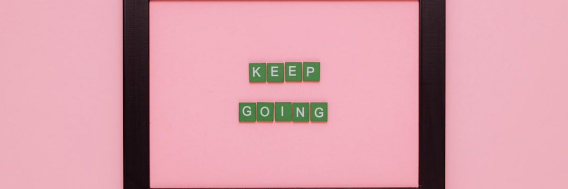 A framed motivational quote on a pink background for inspiration.